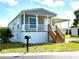 Charming single-story home with covered porch, carport, and well-maintained landscaping at 105 W Saint Johns Way, Apollo Beach, FL 33572