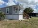 Charming home exterior with gray siding, white trim, and a covered front porch at 105 W Saint Johns Way, Apollo Beach, FL 33572