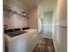 A laundry room features modern side by side washer and dryer, with storage space at 105 W Saint Johns Way, Apollo Beach, FL 33572