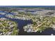 Picturesque aerial view of a residential neighborhood situated on canals, with easy boat access to the bay and beautiful sunny skies at 107 6Th Nw St, Ruskin, FL 33570