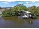 Aerial view of a waterfront property with a private dock and boat lift, showcasing its prime waterfront location at 107 6Th Nw St, Ruskin, FL 33570