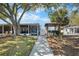 Backyard patio area with an outdoor bar setup and walkway, perfect for entertaining and relaxation at 107 6Th Nw St, Ruskin, FL 33570