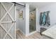 Modern bathroom featuring a glass shower enclosure and stylish barn door at 107 6Th Nw St, Ruskin, FL 33570