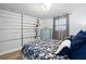 Comfortable bedroom with a patterned bedspread, dresser, and fishing pole rack for the outdoor enthusiast at 107 6Th Nw St, Ruskin, FL 33570