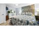 Comfortable bedroom featuring a decorative wood accent wall, and stylish furnishings at 107 6Th Nw St, Ruskin, FL 33570