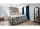 Comfortable bedroom featuring a decorative wood accent wall, and stylish furnishings at 107 6Th Nw St, Ruskin, FL 33570