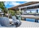Covered boat lift with seating area for relaxing and enjoying waterfront views and boat access at 107 6Th Nw St, Ruskin, FL 33570