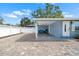 Paved driveway with a covered carport, providing convenient access to the front entrance at 107 6Th Nw St, Ruskin, FL 33570