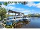 Dock with boat lift providing convenient access to the water and showcasing waterfront living at 107 6Th Nw St, Ruskin, FL 33570