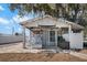A close-up view of the exterior of the shed, complemented by outdoor decor and rocking chairs at 107 6Th Nw St, Ruskin, FL 33570