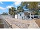 Exterior view of the charming shed with a brick driveway, enhancing the property's curb appeal at 107 6Th Nw St, Ruskin, FL 33570