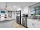 Modern kitchen featuring stainless steel appliances, island seating, and contemporary design at 107 6Th Nw St, Ruskin, FL 33570