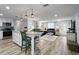 Open-concept living space features an eat-in kitchen island and a comfortable seating area at 107 6Th Nw St, Ruskin, FL 33570