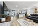 Open-concept living area with modern flooring, a spacious kitchen island, and comfortable seating at 107 6Th Nw St, Ruskin, FL 33570