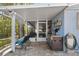 Outdoor kitchen featuring built-in grill, counter space, and screened-in space for outdoor cooking and dining at 107 6Th Nw St, Ruskin, FL 33570