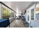 Inviting sunroom with comfortable seating, dining area, and large windows providing lots of natural light at 107 6Th Nw St, Ruskin, FL 33570