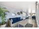 Relaxing sunroom with a comfortable sofa, coffee table, and screened windows offering a tranquil retreat at 107 6Th Nw St, Ruskin, FL 33570