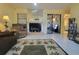 Inviting living room with fireplace, tile flooring, comfortable armchair, and sliding glass doors at 111 Lakeside Colony Dr, Tarpon Springs, FL 34689