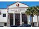 Exterior of Tarpon Springs High School with large windows, columns, and manicured landscaping at 111 Lakeside Colony Dr, Tarpon Springs, FL 34689