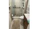 Updated bathroom featuring a tiled shower with grab bars, modern fixtures, and a neutral color scheme at 111 Woodland Pl, Osprey, FL 34229