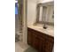 Bathroom with a vanity cabinet, classic mirror and medicine cabinet, and a shower-tub combo at 111 Woodland Pl, Osprey, FL 34229