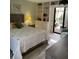 Cozy bedroom with built-in shelves, sliding glass doors to the private patio, and a comfortable bed at 111 Woodland Pl, Osprey, FL 34229