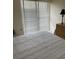 Comfortable bedroom with a large window and blinds, a woven dresser, and neutral decor at 111 Woodland Pl, Osprey, FL 34229