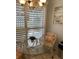 Cozy breakfast nook with a glass-top table, a cushioned chair, and shutters for natural light at 111 Woodland Pl, Osprey, FL 34229