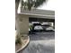 View of the carport showing the parking space with 2 vehicles parked beneath a wooden covering at 111 Woodland Pl, Osprey, FL 34229