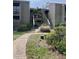 Inviting exterior of a multi-story home with lush landscaping and a serene walkway leading to the entrance at 111 Woodland Pl, Osprey, FL 34229