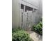 Exterior view showing a gated wooden fence in a shady area surrounded by greenery and foliage at 111 Woodland Pl, Osprey, FL 34229