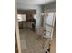 View of the kitchen with white cabinets, stainless steel appliances, and a breakfast nook seating area at 111 Woodland Pl, Osprey, FL 34229