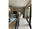 Bright living room featuring modern furnishings, sliding glass doors, and light wood flooring at 111 Woodland Pl, Osprey, FL 34229