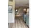 An open living room featuring light wood flooring, comfortable seating, and a bright airy atmosphere at 111 Woodland Pl, Osprey, FL 34229