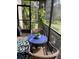 Screened-in patio features wicker furniture and an outdoor view at 111 Woodland Pl, Osprey, FL 34229