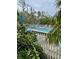 The community pool is surrounded by tropical trees and shrubbery providing a tranquil setting at 111 Woodland Pl, Osprey, FL 34229