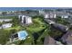 An aerial shot displays a golf course, pool, tennis court, and waterfront views from the beautiful condos at 11450 Harbor Way # 5002, Largo, FL 33774