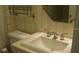Cozy bathroom with a classic vanity, decorative fixtures, and a framed mirror at 11450 Harbor Way # 5002, Largo, FL 33774