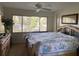 Bright bedroom featuring a four-poster bed, large window with blinds, and ample natural light at 11450 Harbor Way # 5002, Largo, FL 33774