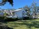 Charming home with landscaped yard, lush greenery, and a clear blue sky at 11450 Harbor Way # 5002, Largo, FL 33774