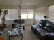 Cozy living room with ample natural light, comfortable seating, and a glass coffee table at 11450 Harbor Way # 5002, Largo, FL 33774