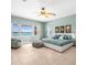 This bedroom boasts stunning water views from its large windows and a calming interior design at 1445 Corey S Way, South Pasadena, FL 33707