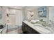 Elegant bathroom with double sinks, granite countertops, and a tiled shower/tub combo at 14637 Red Castle Ave, Lithia, FL 33547