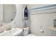 Charming half bathroom with nautical-themed decor, featuring a decorative mirror and a wall-mounted boat shelf at 14637 Red Castle Ave, Lithia, FL 33547