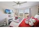 Colorful bedroom with a work space, tv, and a large window with a view to the exterior at 14637 Red Castle Ave, Lithia, FL 33547