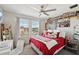 Bright bedroom with a large window, a desk, and shelves filled with fun figures at 14637 Red Castle Ave, Lithia, FL 33547