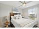 Charming bedroom featuring a plush bed, decorative pillows, and a sunlit window at 14637 Red Castle Ave, Lithia, FL 33547