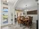 Elegant dining room featuring stylish wood-look tile, modern chandelier, and neutral decor to complement the natural light at 14637 Red Castle Ave, Lithia, FL 33547