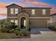 Charming two-story home featuring an arched entryway, a well-manicured lawn, and an attached two-car garage at 14637 Red Castle Ave, Lithia, FL 33547