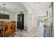 Bright hallway with wood-look tile leading to the staircase, dining area, and the backyard pool at 14637 Red Castle Ave, Lithia, FL 33547